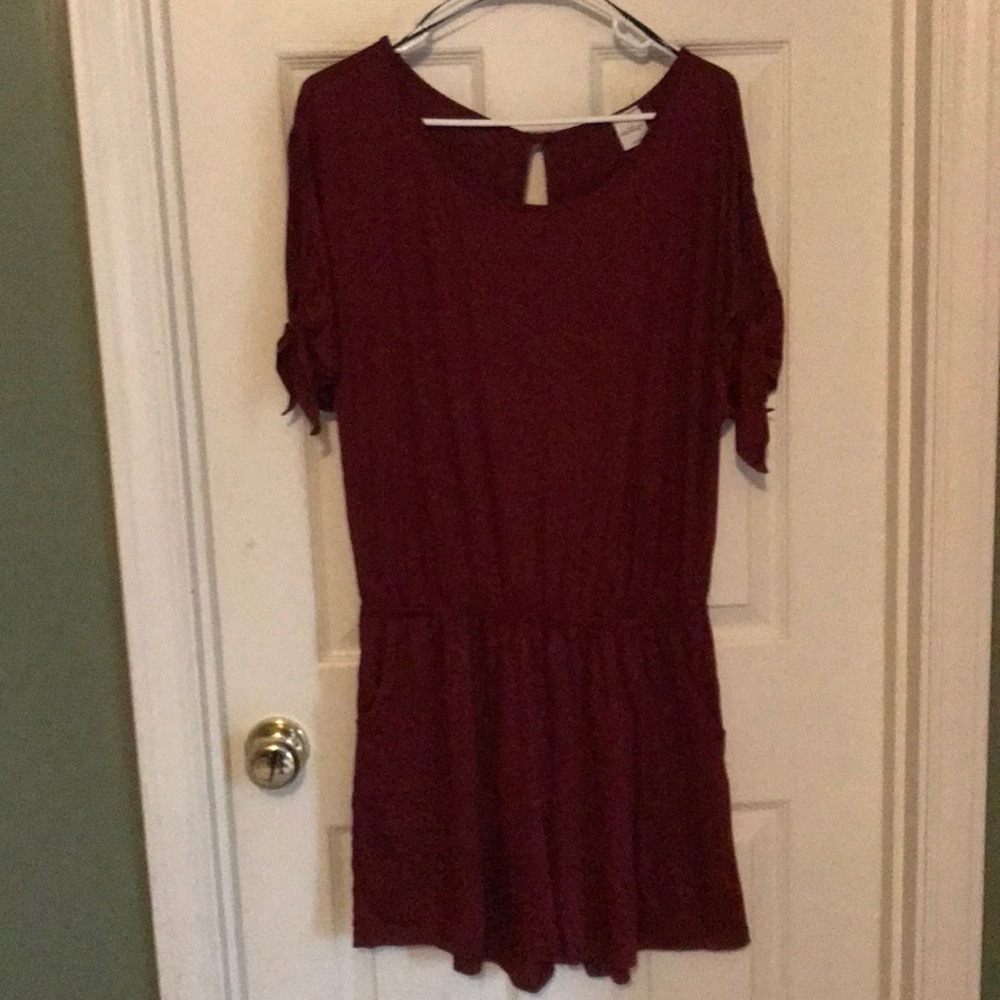 Burgundy romper with shorts and cold shoulder.